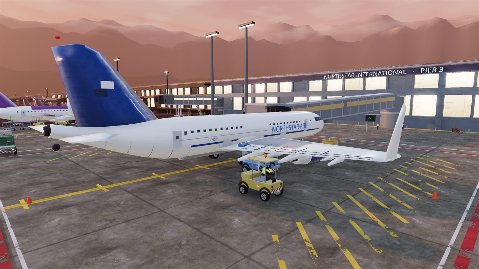 An airliner parked on stand at sunset, a tug at the nose gear and the terminal pier behind it.